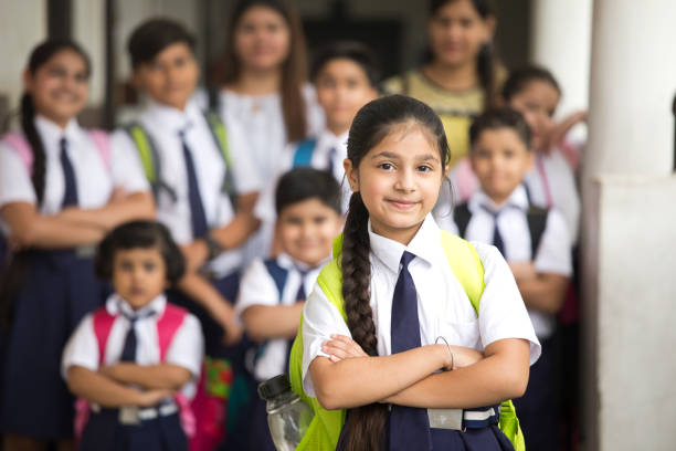 group of indian schoolboys and schoolgirls at school campus